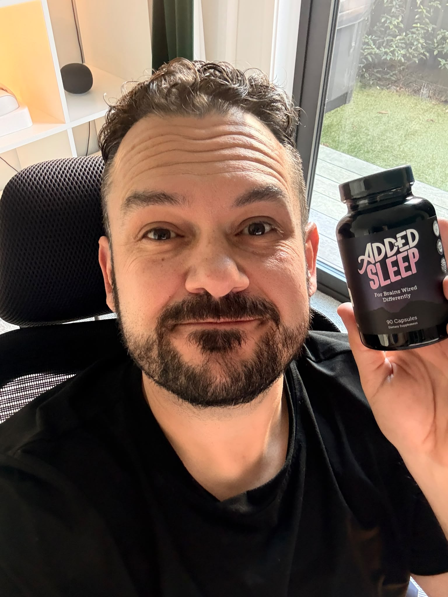 Stephen holding a bottle of Added Sleep
